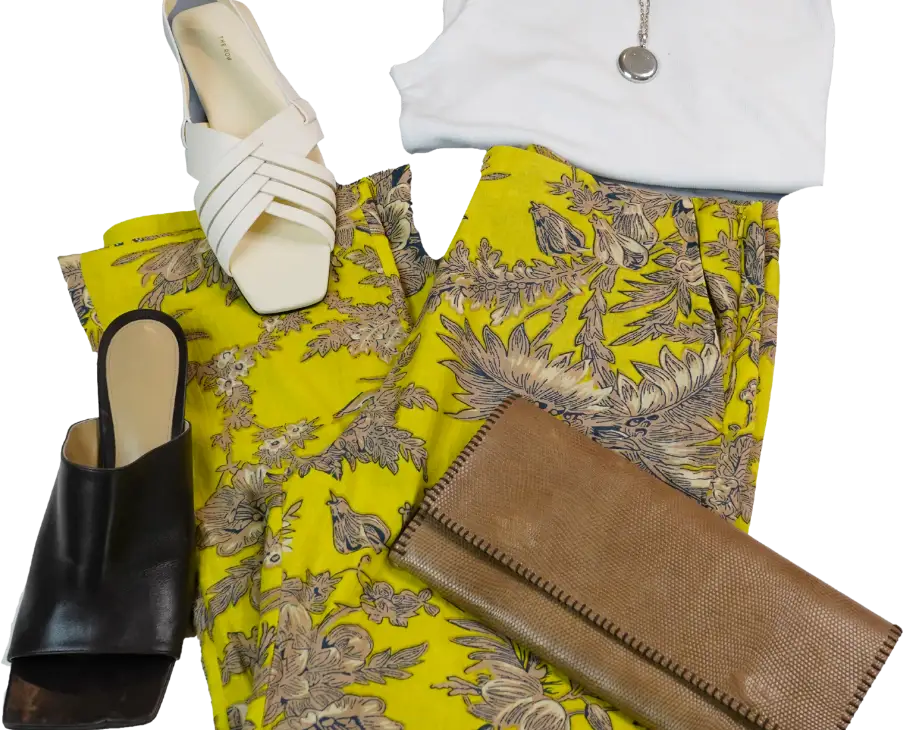 outfit laid out with bright pants, clutch, shoe options, shirt, necklace